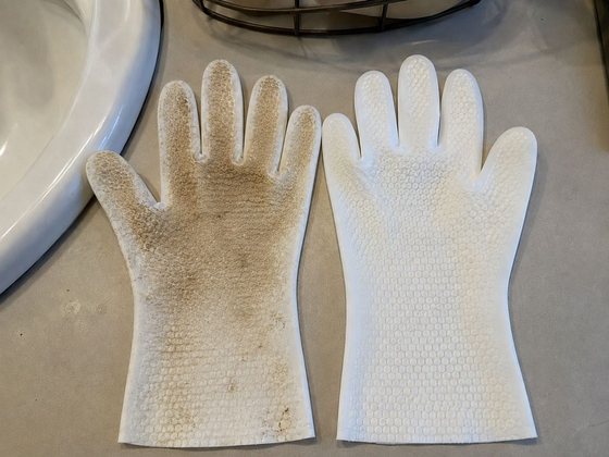 A used grooming glove next to a clean one, showing the dirt lifted from a dog's coat